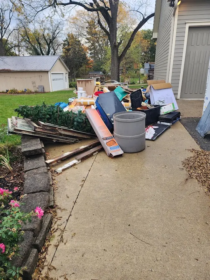 Dumpster being loaded with debris for Estate Cleanout Dumpster Rental in Jenkins
